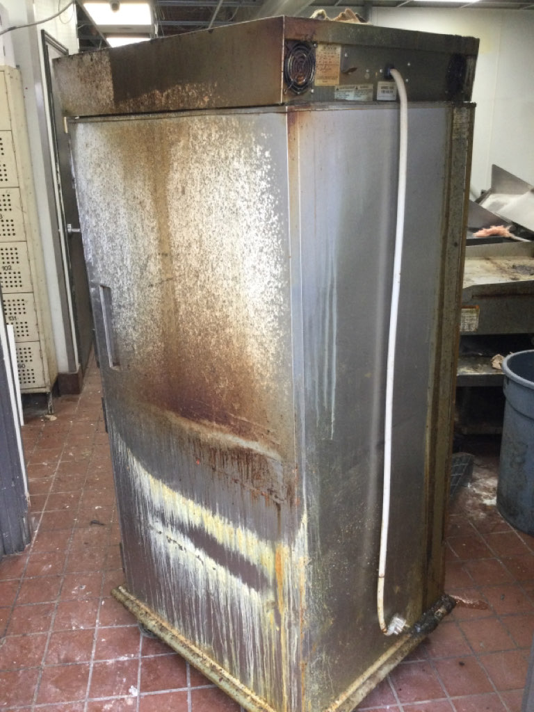 Soot and fire-damaged double oven before restoration